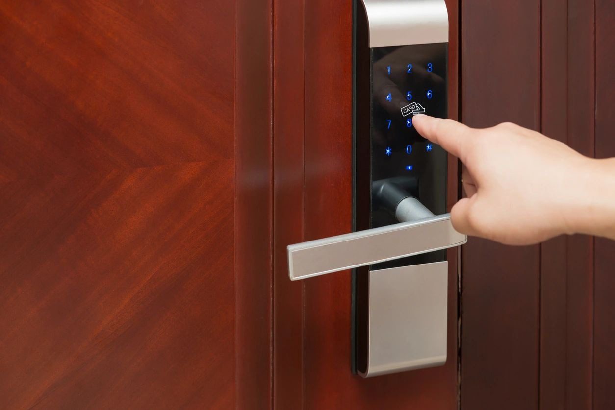 A person is touching the screen on an electronic door lock.